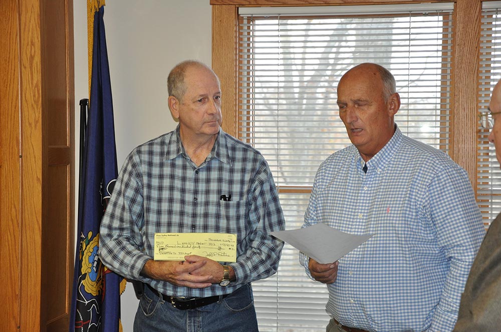 Jeff Pontius of Penn Valley Railroad presents Norm Barrett with a donation check for Project3713.